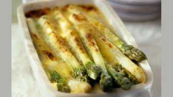 UN GRATIN D'ASPERGES DORÉES AU BEURRE ET NAPPÉES DE CRÈME.
